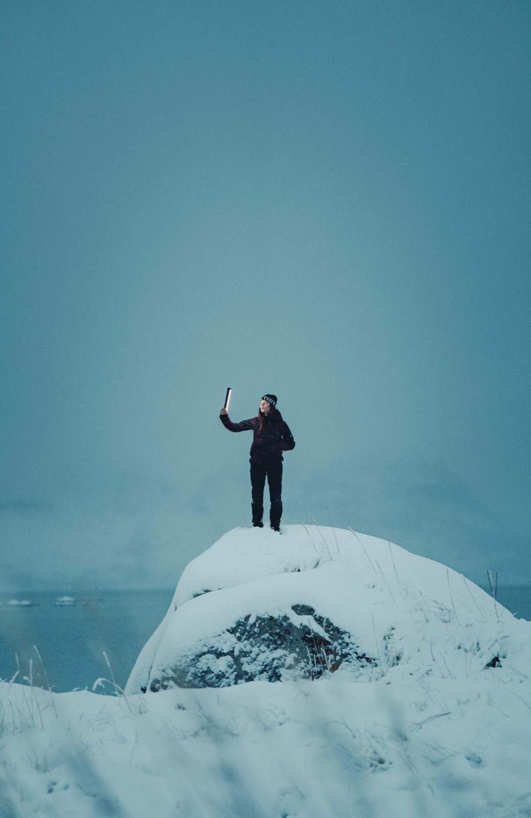 Standing on a snow-covered rock in the Arctic
